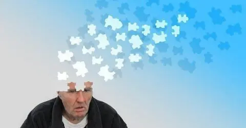 Man with dementia and puzzle pieces leaving his mind