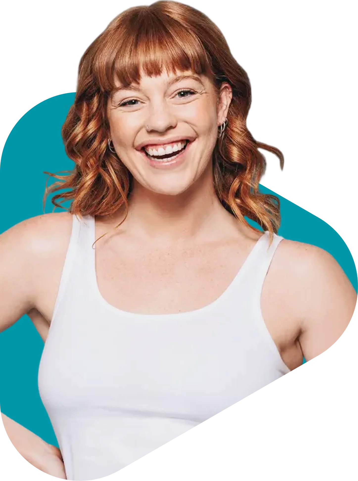 Smiling woman with curly red hair wearing a white tank top against a teal background