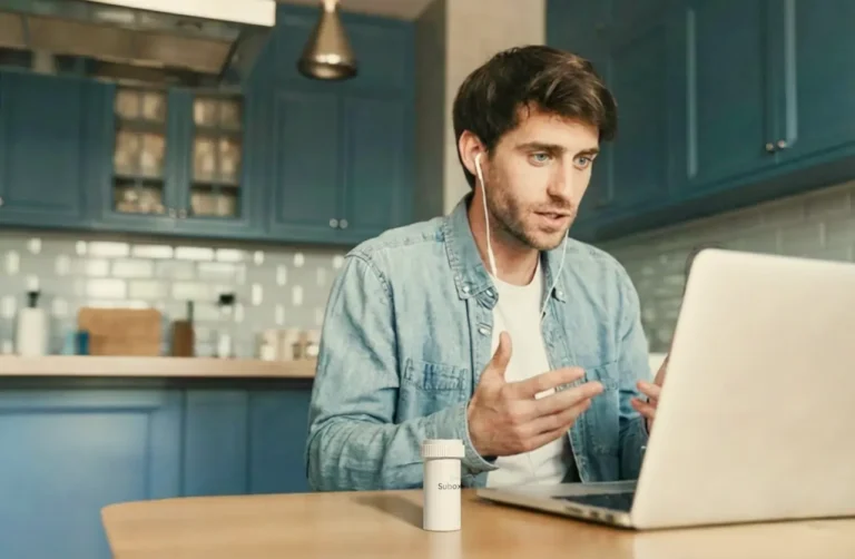 man-on-laptop-speaking-to-doctor-in-kitchen