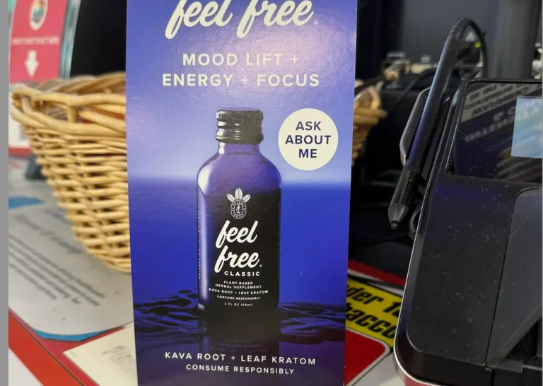 Feel Free Classic kratom and kava root herbal supplement shot bottle promoting mood lift, energy, and focus at a retail counter