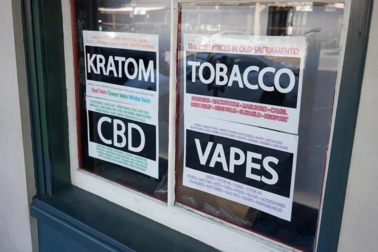 store-window-sign-advertising-kratom-CBD-tobacco-and-vapes-for-sale-in-smoke-shop