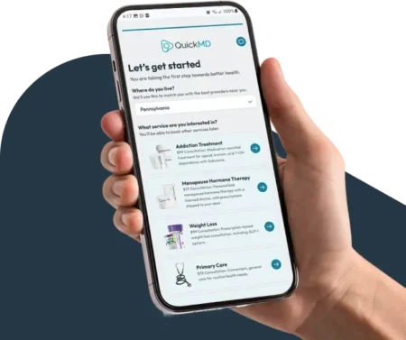 Hand holding a smartphone displaying the QuickMD mobile app's "Let's get started" onboarding screen with healthcare services.