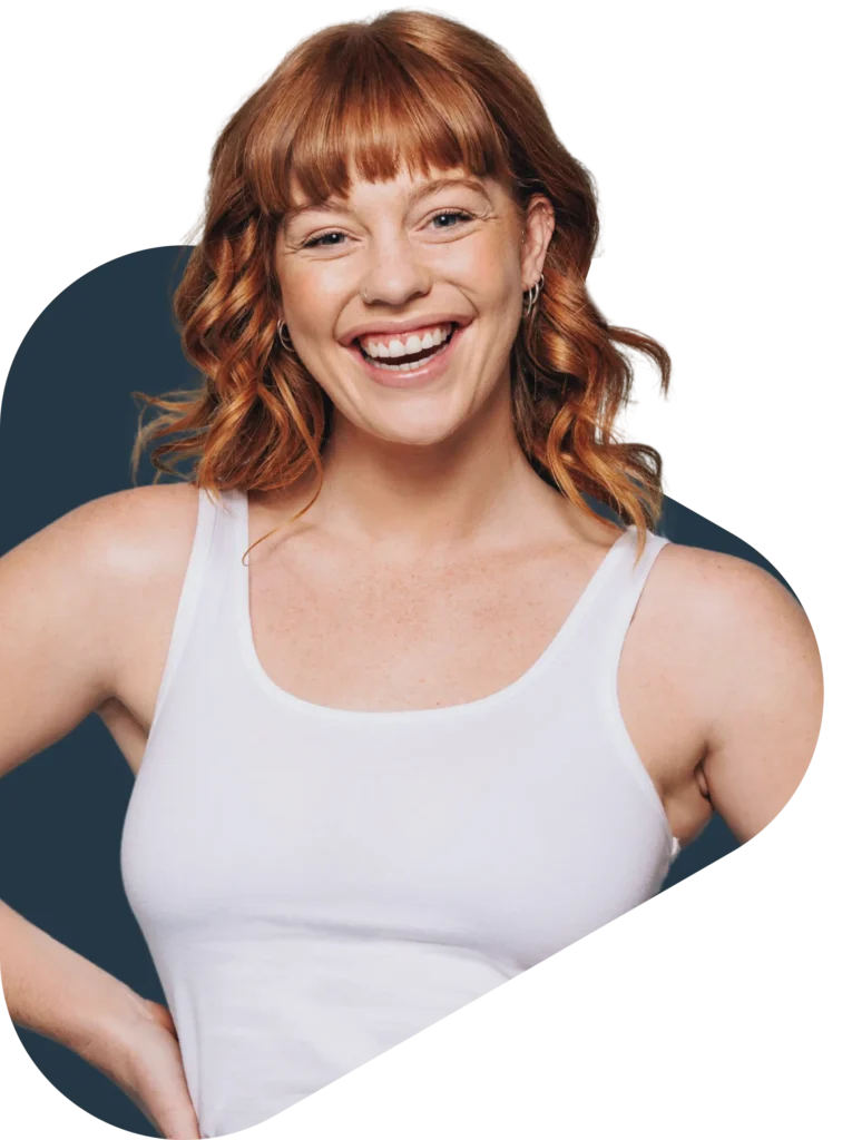 Woman with red hair standing with hand on her hip