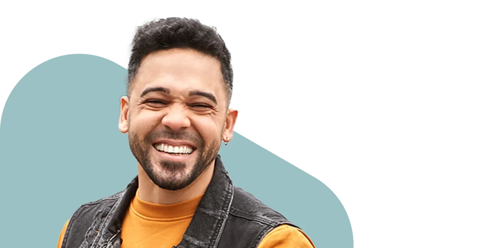 Man with orange shirt smiling