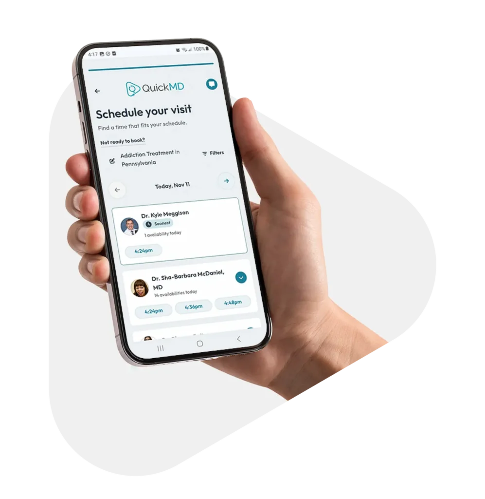 QuickMD app on smartphone displaying different doctors and time slots