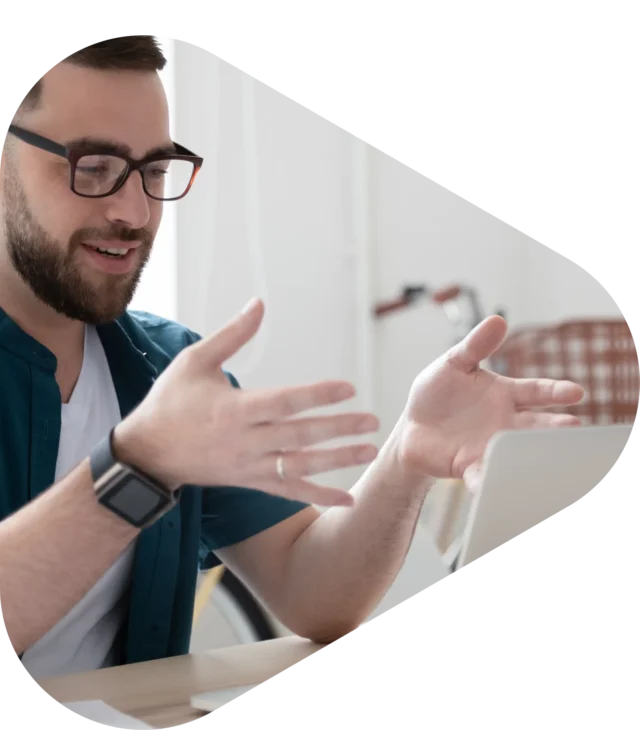 Man with glasses speaking to telehealth professional on his computer